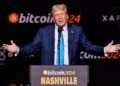 "Trump speaking at rally with Bitcoin logo"